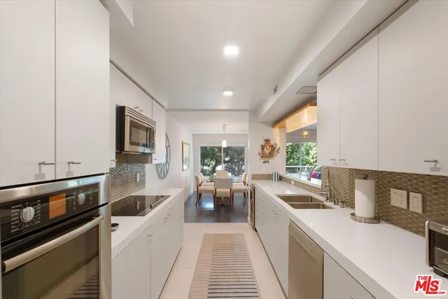 a kitchen with a sink cabinets and window