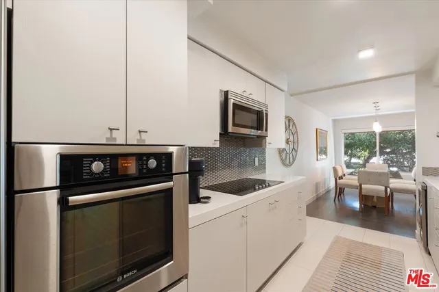 a kitchen with stainless steel appliances a stove microwave and sink