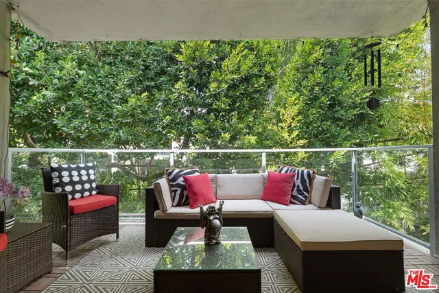 a roof deck with a couch and chairs