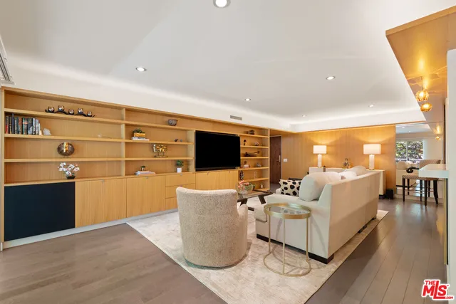 a living room with furniture wooden floor and a flat screen tv