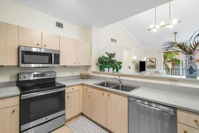 a kitchen with a sink stove and microwave