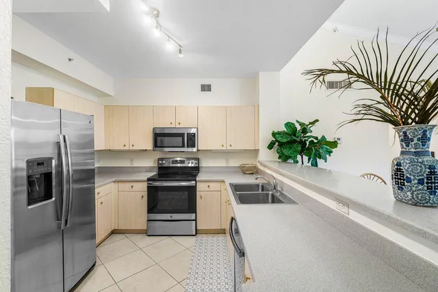 a kitchen with stainless steel appliances a microwave and a refrigerator