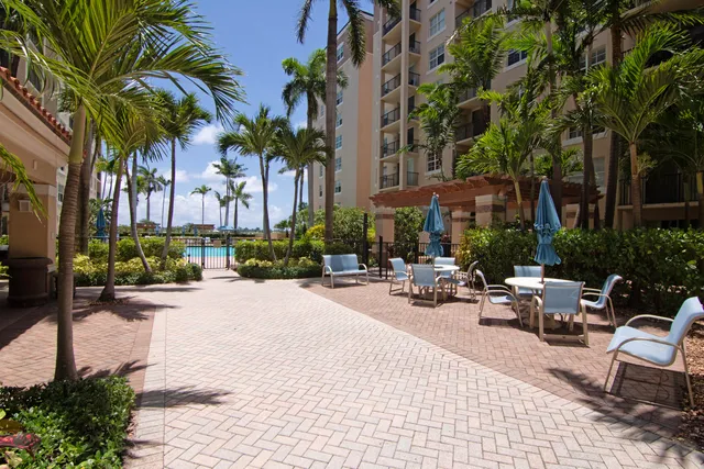 a row of palm trees in front of a house