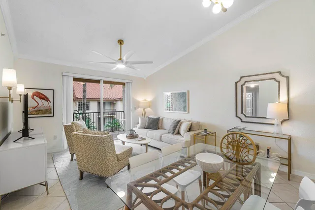 a living room with furniture a window and a chandelier
