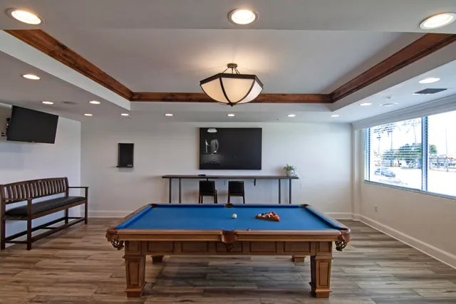 a living room with furniture a table and a potted plant
