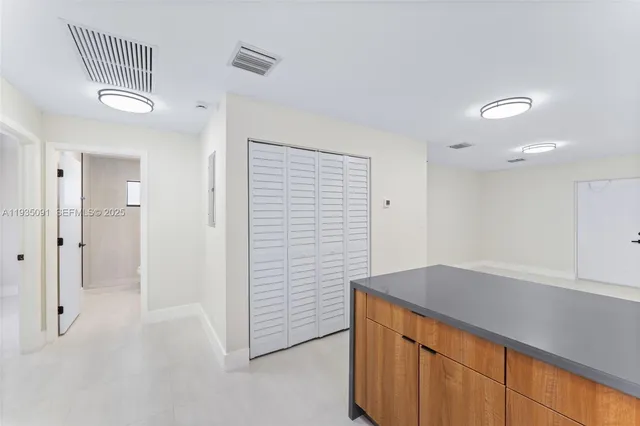 a kitchen with a refrigerator and cabinets