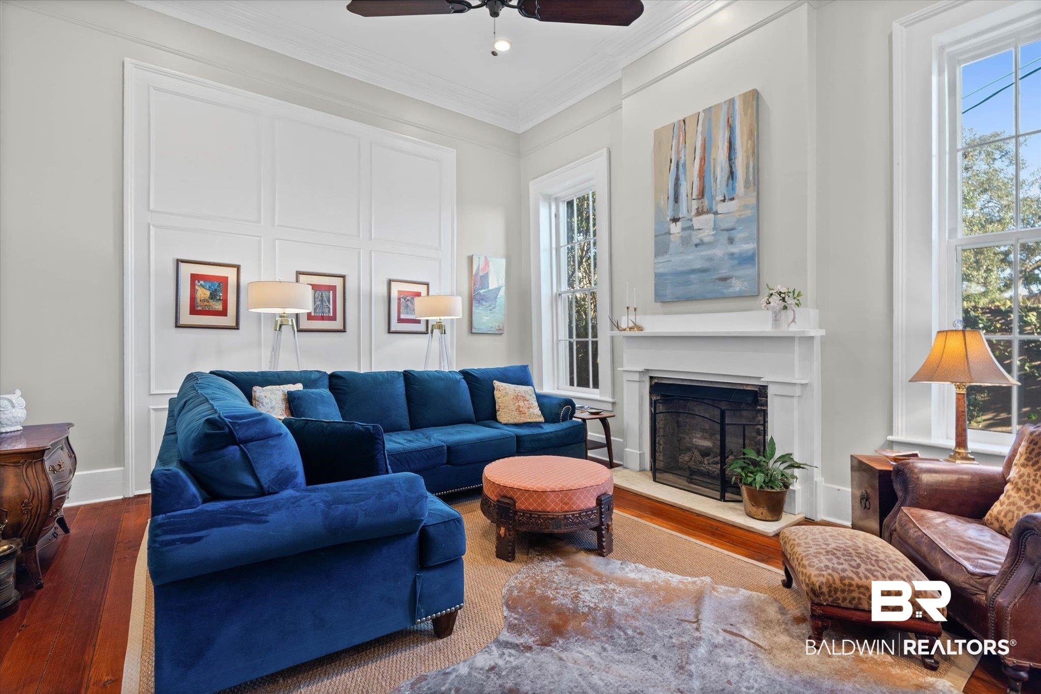259 North Jackson Street Mobile, AL 36603 - Photo 9 of 42 Living area with hardwood / wood-style floors, a fireplace with raised hearth, ornamental molding, ceiling fan, and a decorative wall