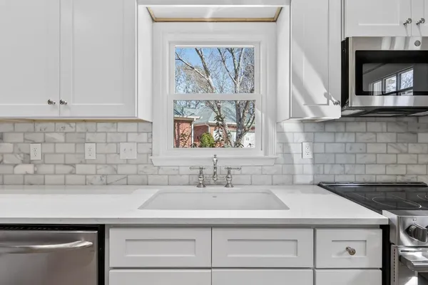 a sink with a stove and cabinets