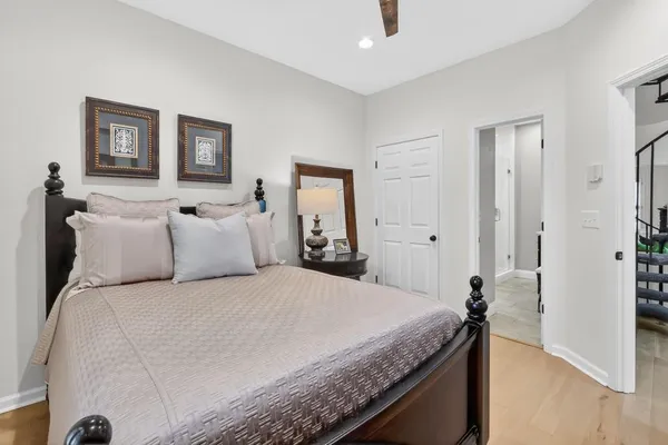 a bedroom with a bed and a painting on the wall