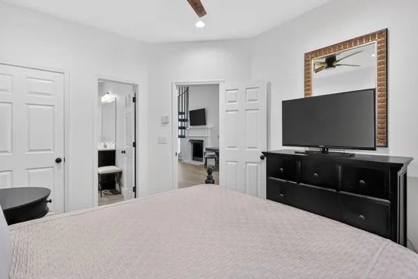 a bedroom with a bed and a flat screen tv