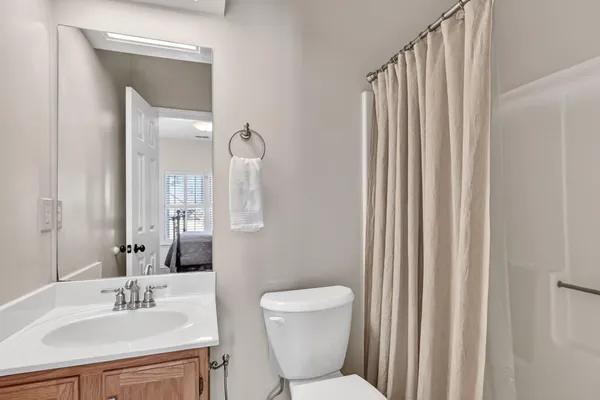 a bathroom with a toilet a sink and a mirror