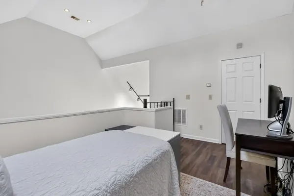 a bedroom with a bed and a table in it
