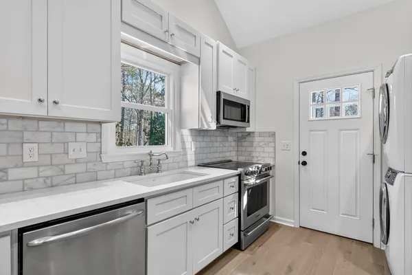 a kitchen with a sink cabinets and window