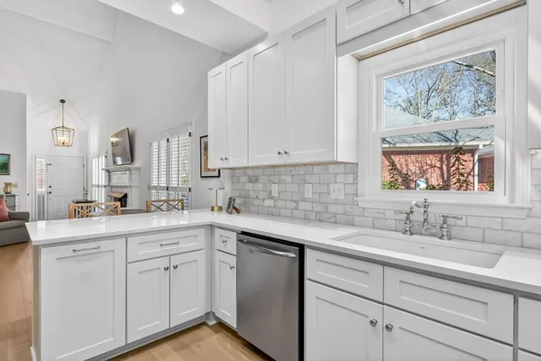 a kitchen with a sink cabinets and window