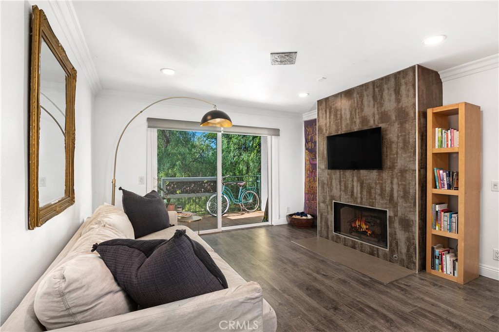 a living room with fireplace furniture and a flat screen tv