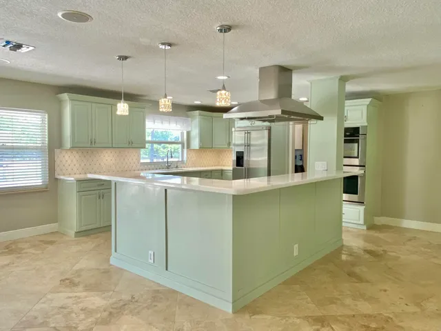 a kitchen with cabinets a sink and appliances