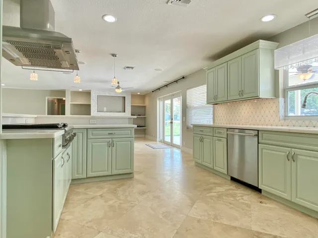 a kitchen with stainless steel appliances granite countertop a stove and a sink