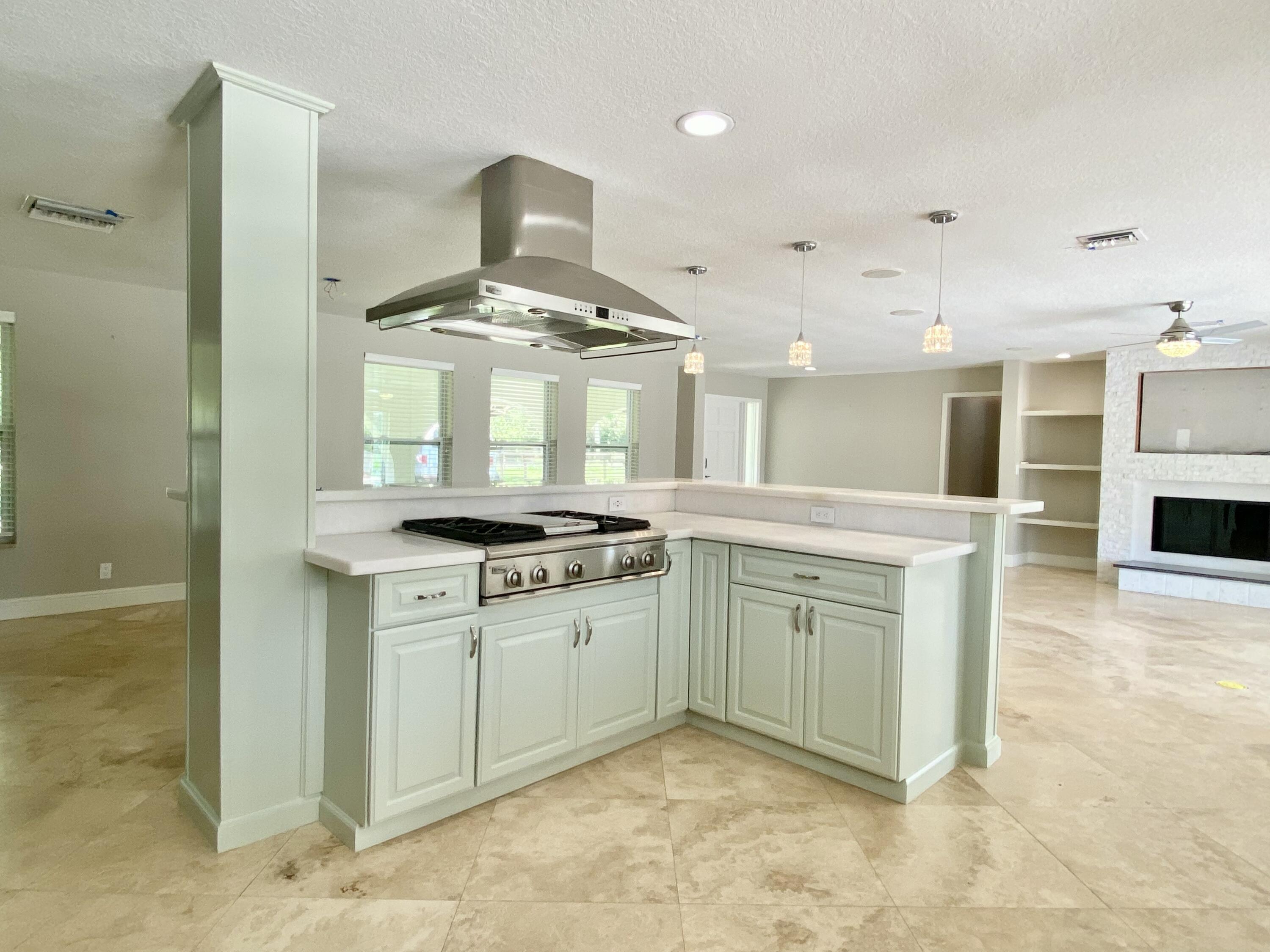16605 115th Avenue North Jupiter, FL 33478 - Photo 15 of 54 a kitchen with stainless steel appliances granite countertop a stove and a sink