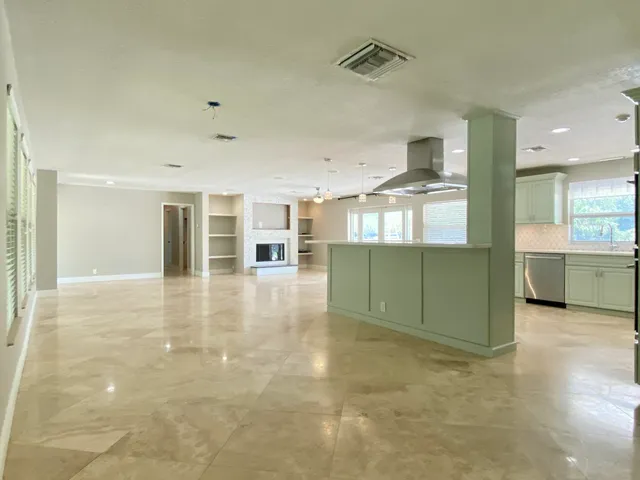 a view of a kitchen with a sink and cabinets