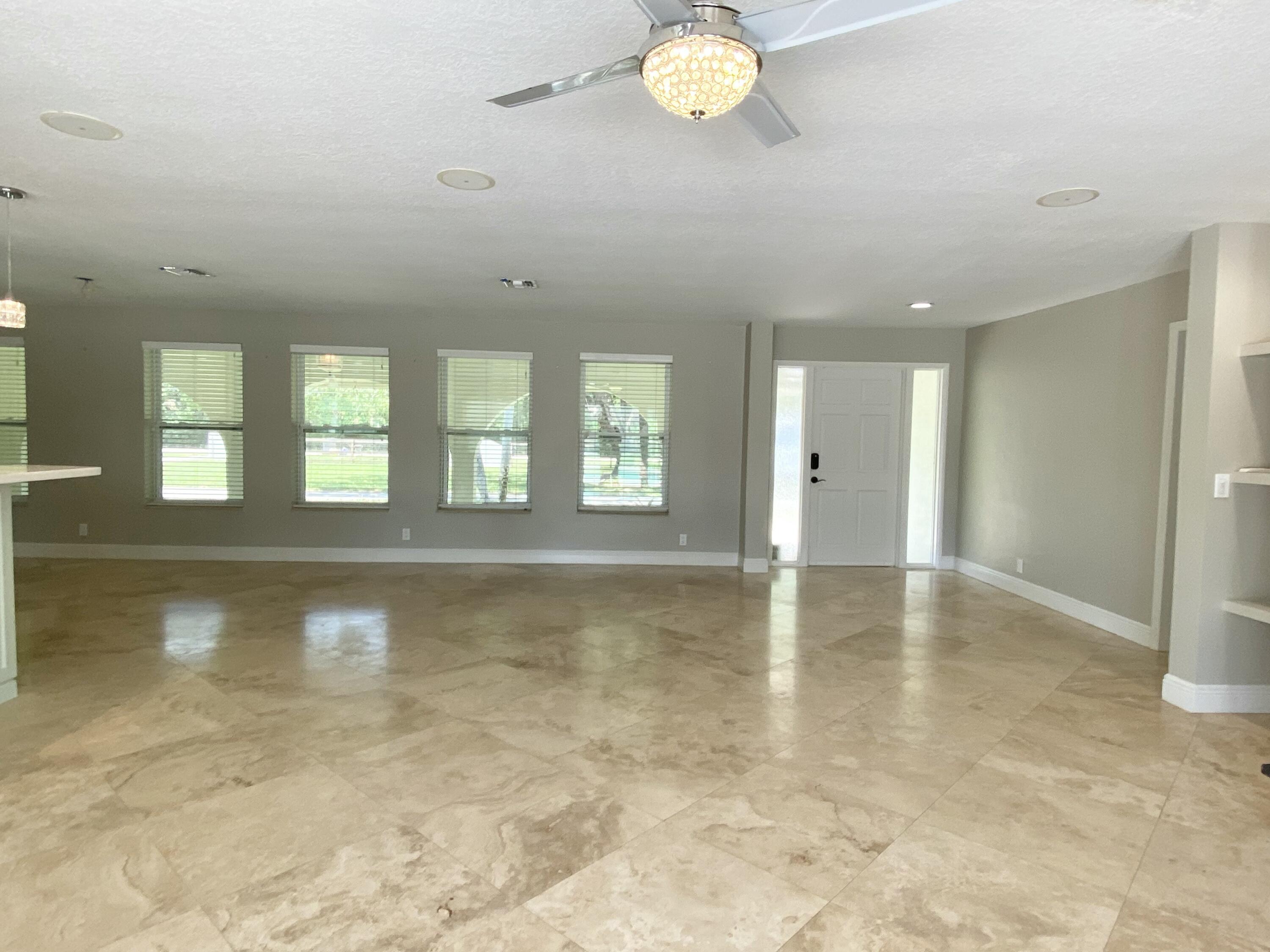 16605 115th Avenue North Jupiter, FL 33478 - Photo 21 of 54 a view of an empty room with window and wooden floor