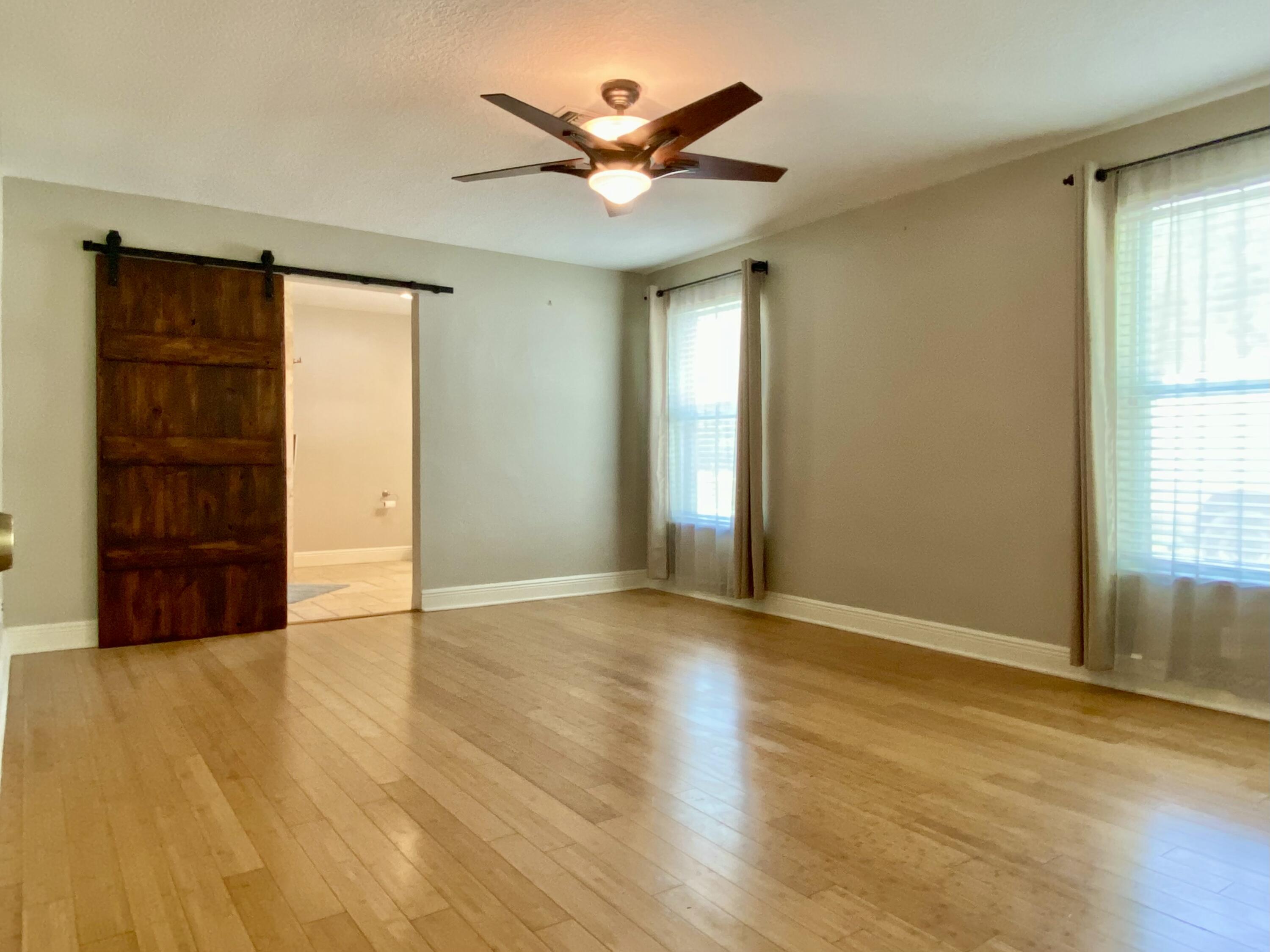 16605 115th Avenue North Jupiter, FL 33478 - Photo 23 of 54 a view of an empty room with closet and wooden floor