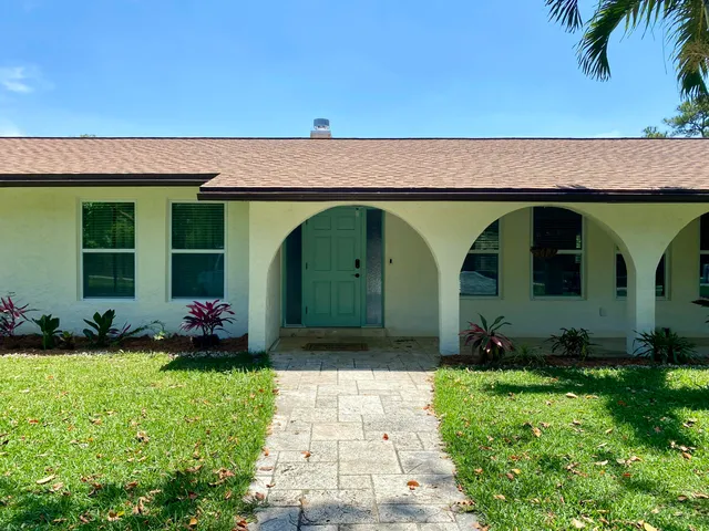 a view of a swimming pool with a yard