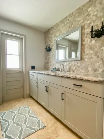 a bathroom with a toilet sink and mirror