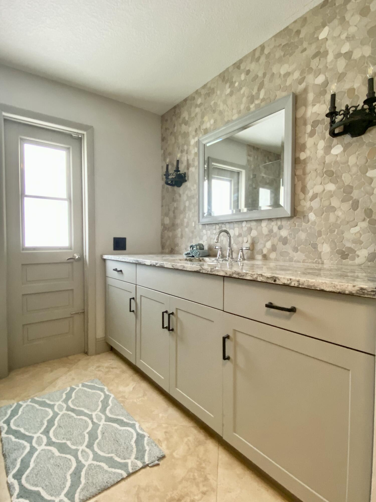16605 115th Avenue North Jupiter, FL 33478 - Photo 34 of 54 a bathroom with a sink and a mirror