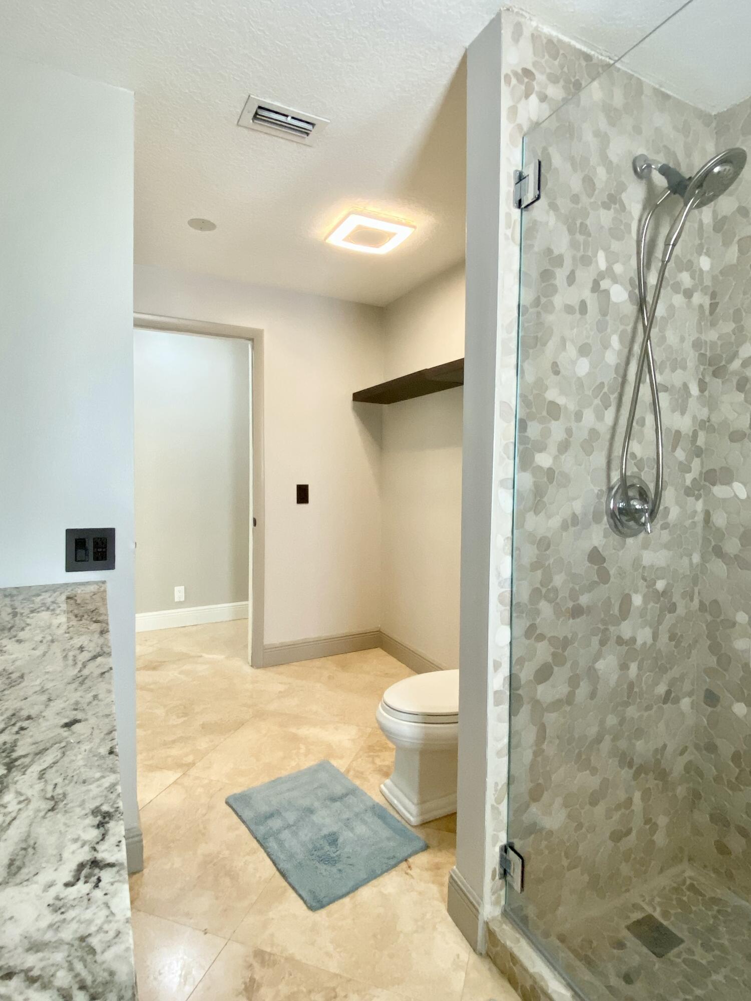 16605 115th Avenue North Jupiter, FL 33478 - Photo 35 of 54 a bathroom with a shower and a toilet
