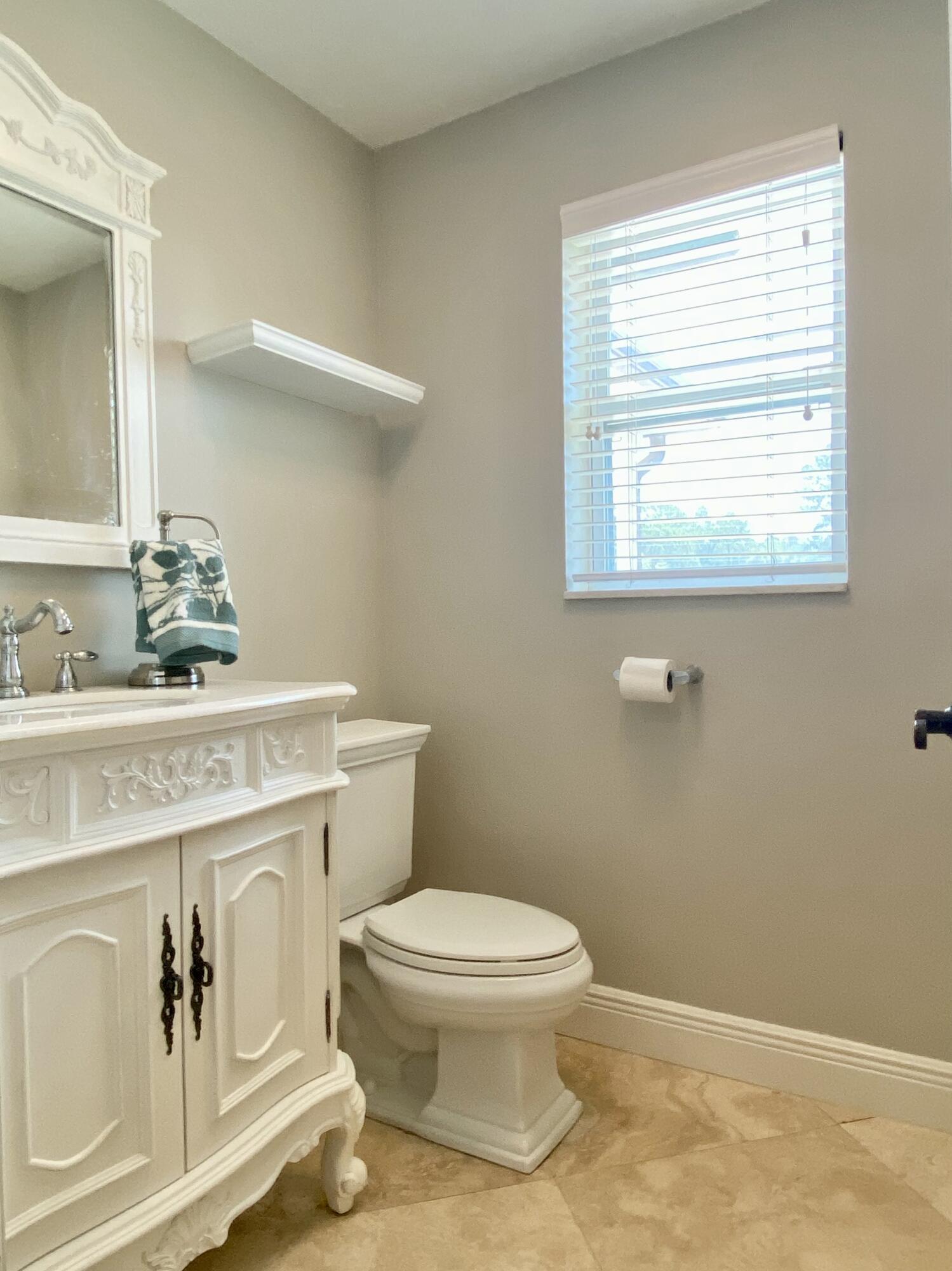 16605 115th Avenue North Jupiter, FL 33478 - Photo 37 of 54 a bathroom with a toilet sink and mirror