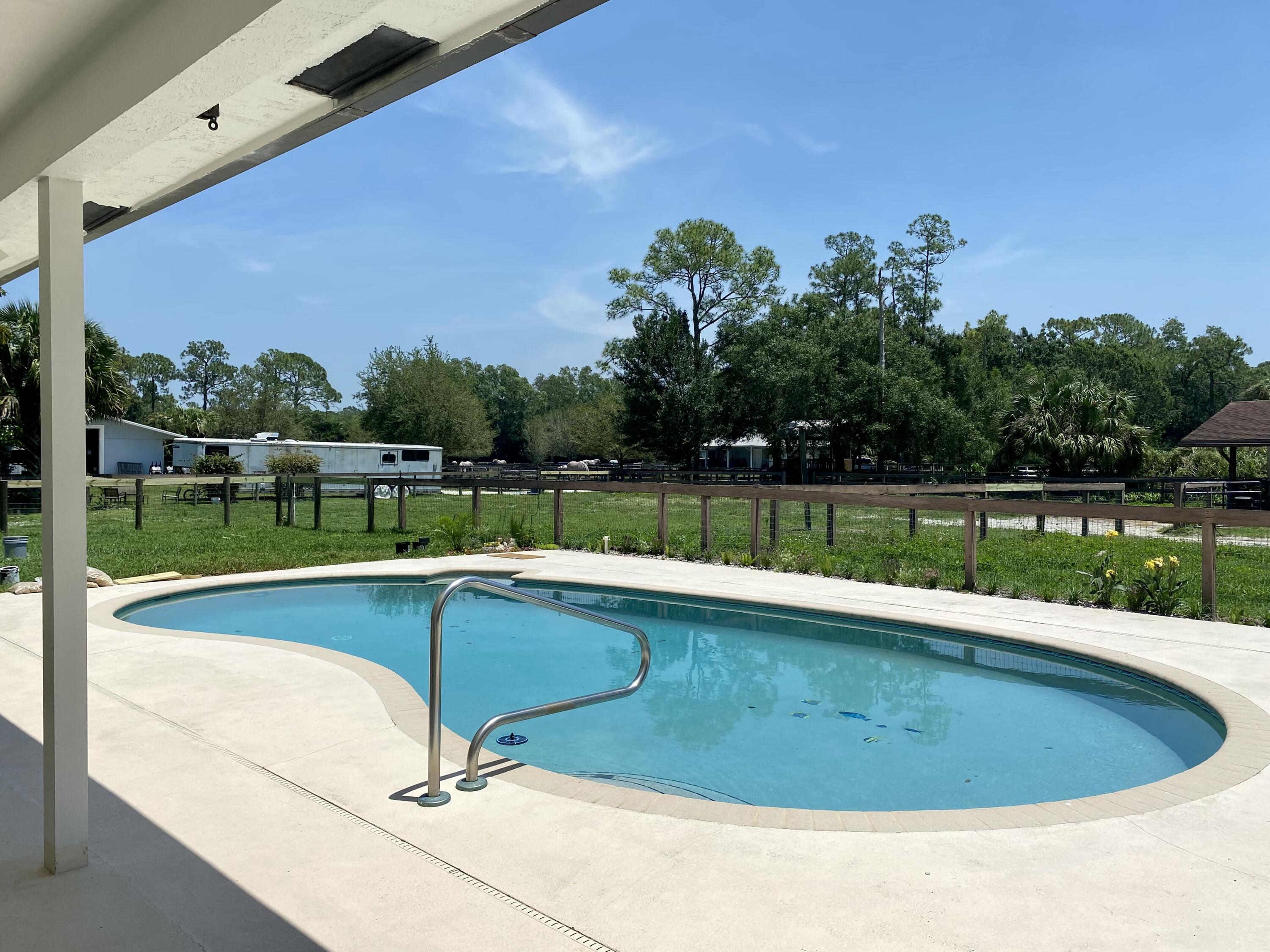 16605 115th Avenue North Jupiter, FL 33478 - Photo 4 of 54 a view of a swimming pool with a yard