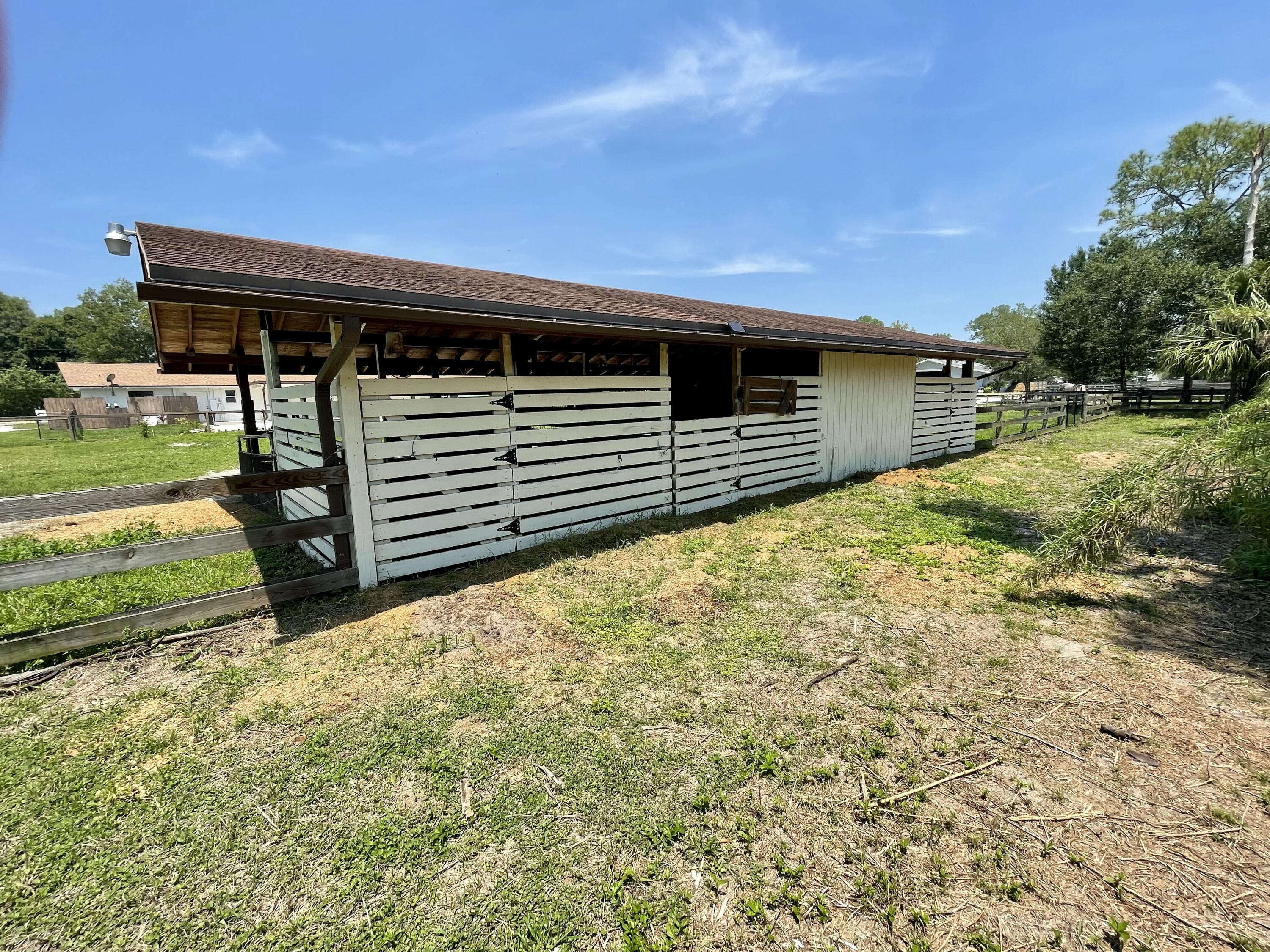 16605 115th Avenue North Jupiter, FL 33478 - Photo 42 of 54 a view of a house with backyard and trees