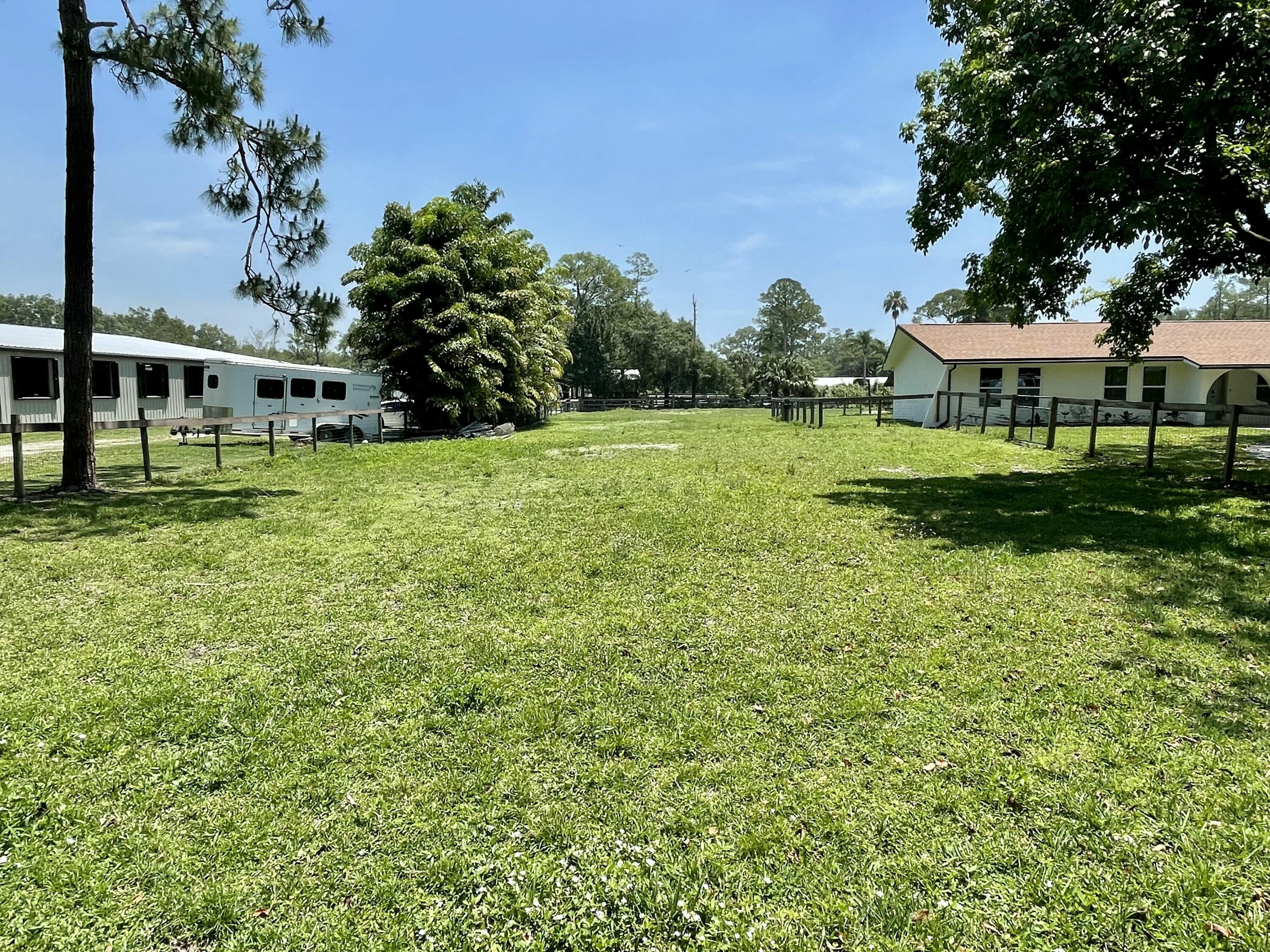 16605 115th Avenue North Jupiter, FL 33478 - Photo 50 of 54 a front view of a house with a yard
