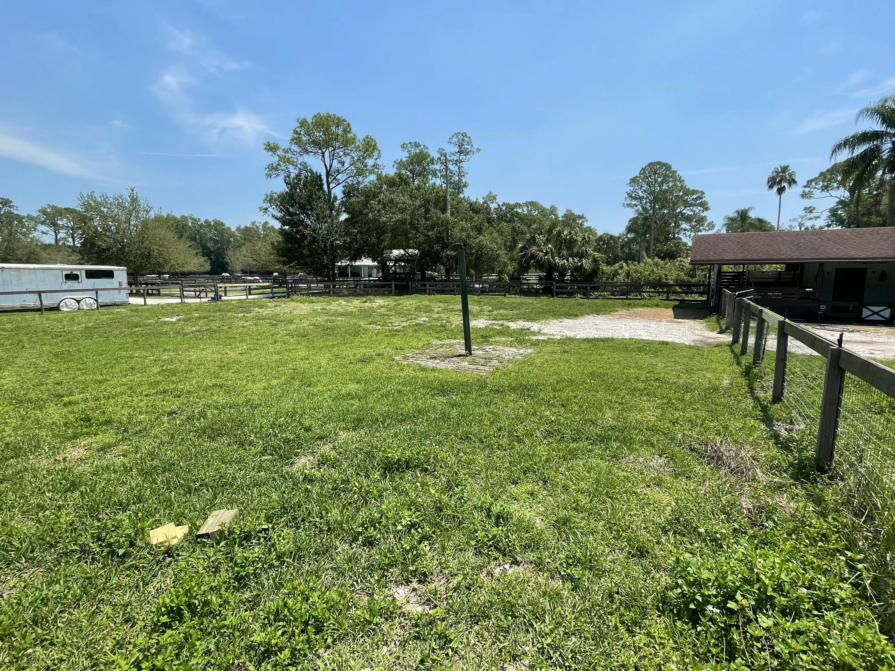 16605 115th Avenue North Jupiter, FL 33478 - Photo 53 of 54 a backyard of a house with table and chairs