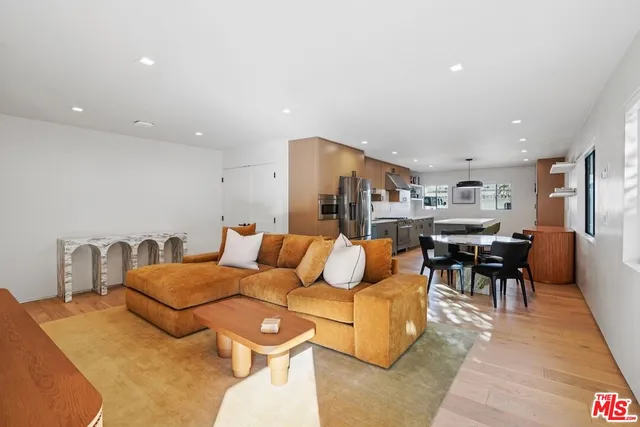 a living room with furniture and kitchen view