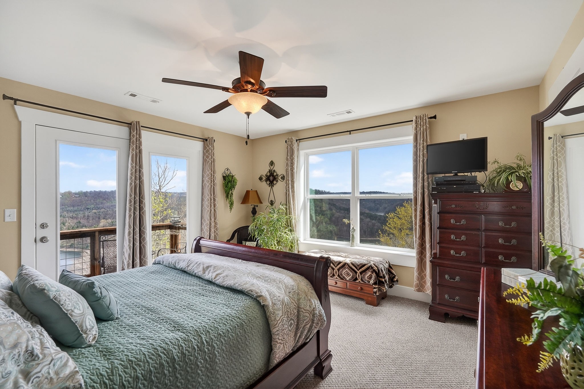 195 Coventry Way Smithville, TN 37166 - Photo 44 of 62 a bedroom with a bed a flat screen tv and a large window