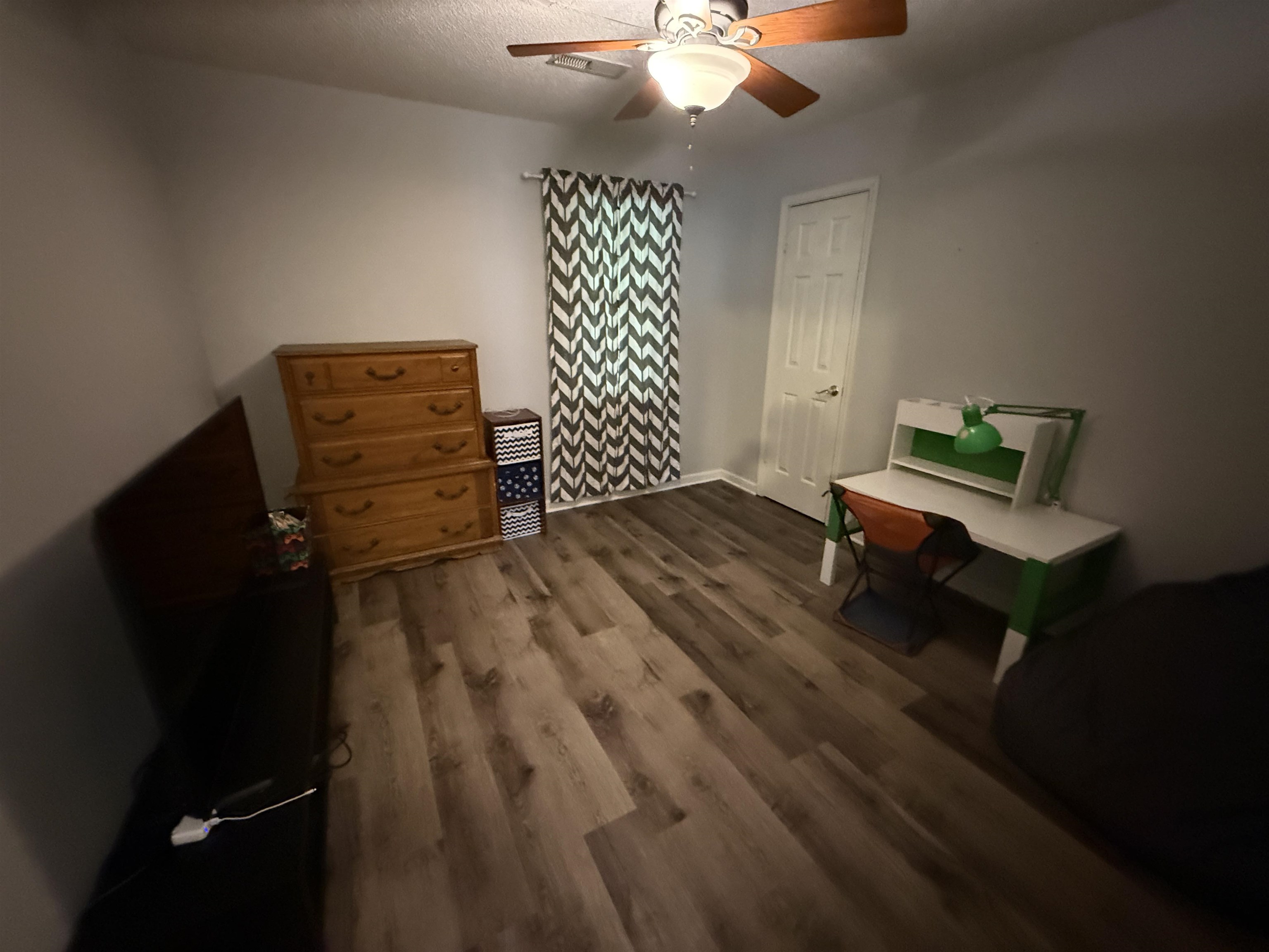 185 Mignon Road Atoka, TN 38004 - Photo 27 of 34 Room featuring wood-finish flooring, a ceiling fan with light fixture, and a white paneled door