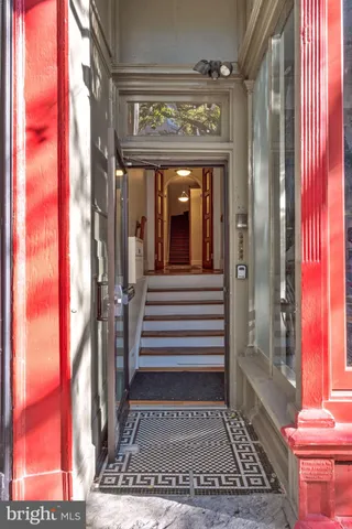 a view of entryway and hall with wooden floor