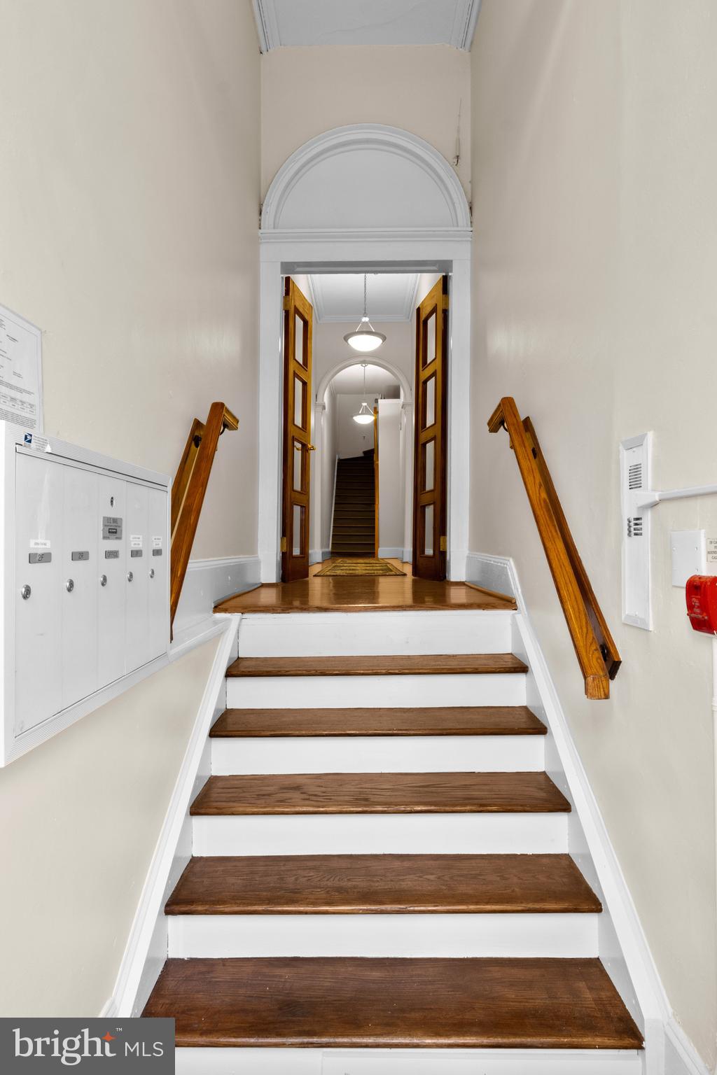 1121 Walnut Street Philadelphia, PA 19107 - Photo 12 of 38 a view of staircase with white walls and a rug