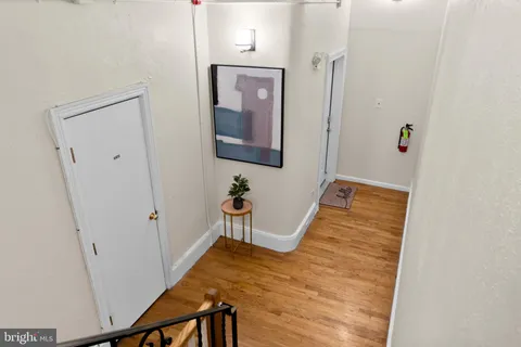 a living room with furniture a fireplace and a chandelier