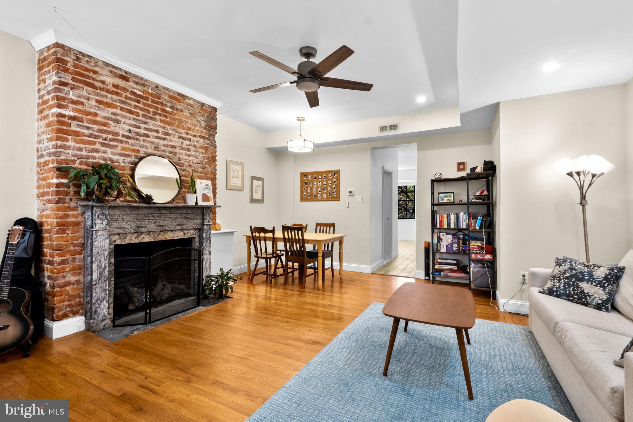 1121 Walnut Street Philadelphia, PA 19107 - Photo 19 of 38 a living room with furniture a fireplace and a ceiling fan