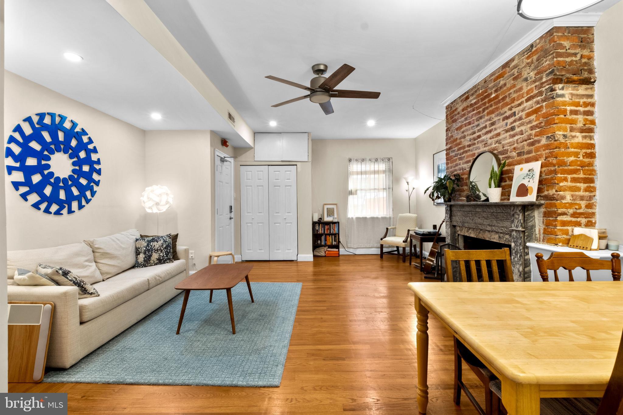 1121 Walnut Street Philadelphia, PA 19107 - Photo 20 of 38 a living room with furniture a fireplace and a chandelier