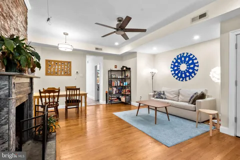 a living room with furniture and a potted plant