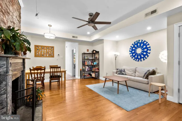 a living room with furniture and a potted plant