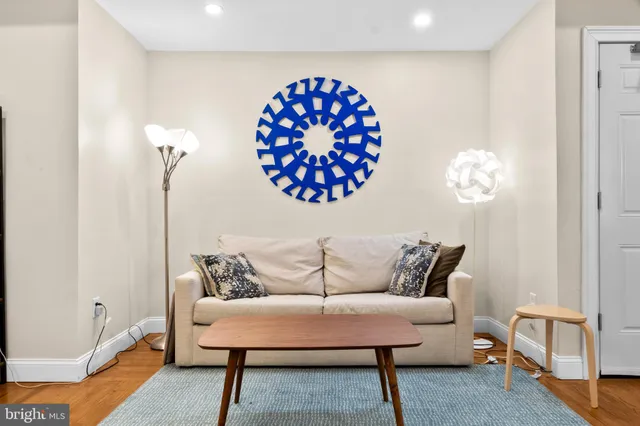 a living room with furniture and a wooden floor