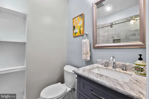 a kitchen with stainless steel appliances granite countertop white cabinets stove a sink and dishwasher