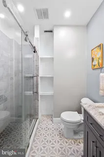 a kitchen with stainless steel appliances granite countertop a stove a sink and white cabinets