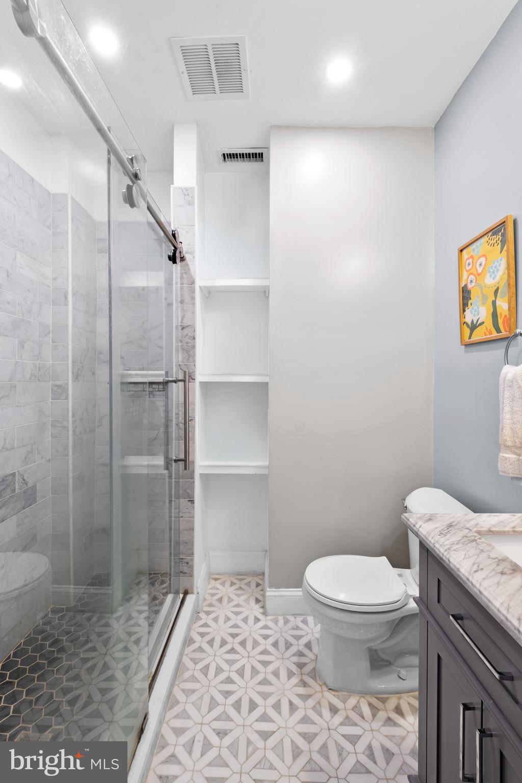 1121 Walnut Street Philadelphia, PA 19107 - Photo 28 of 38 a bathroom with a granite countertop toilet and a shower