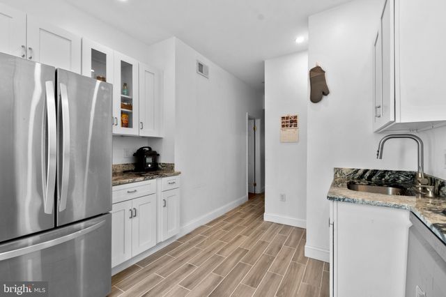 a kitchen with stainless steel appliances white cabinets and a stove a oven with white countertops