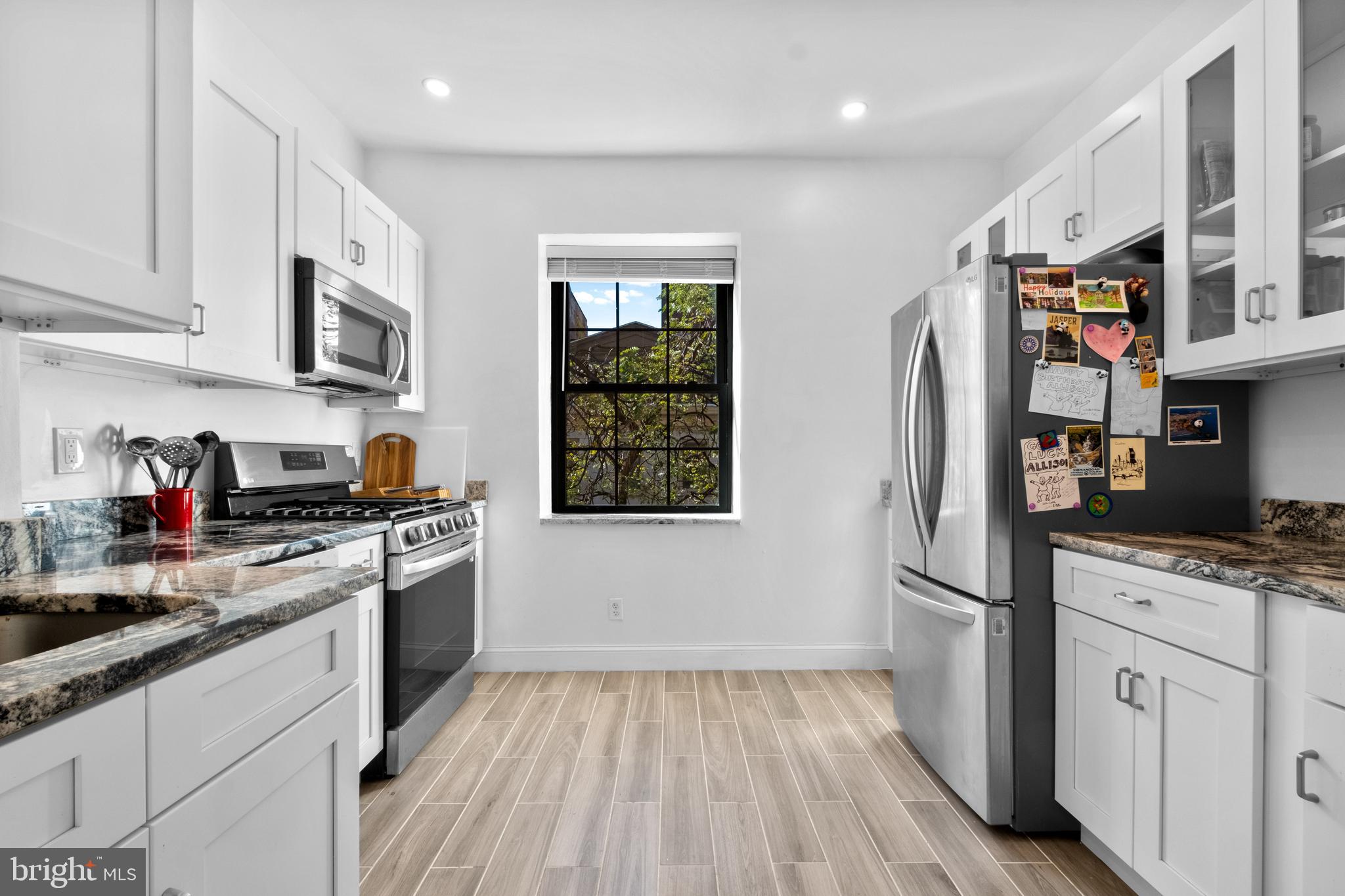 1121 Walnut Street Philadelphia, PA 19107 - Photo 32 of 38 a kitchen with stainless steel appliances granite countertop a refrigerator stove and sink